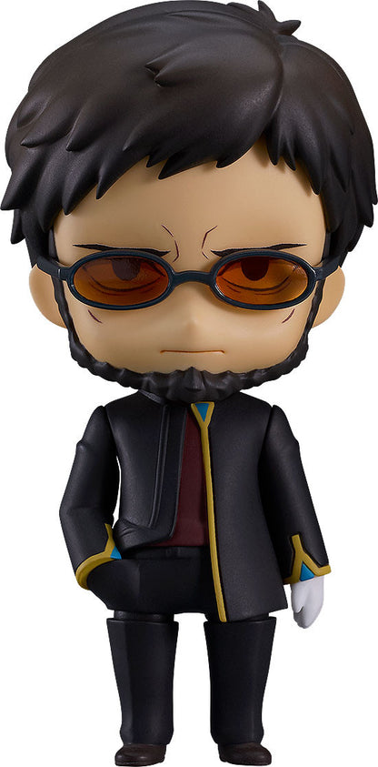 A Nendoroid figure of a man with dark hair, beard, orange sunglasses, and a black coat, standing with a hand in his pocket