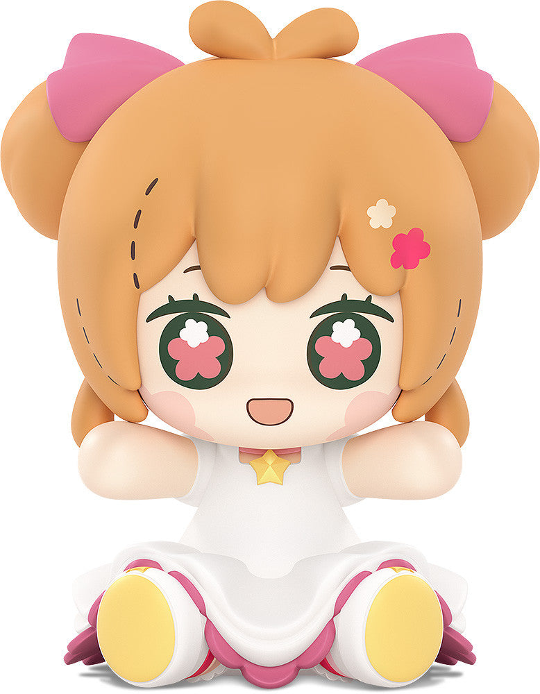 Sakura hugging staff with joyful expression and sparkling dress