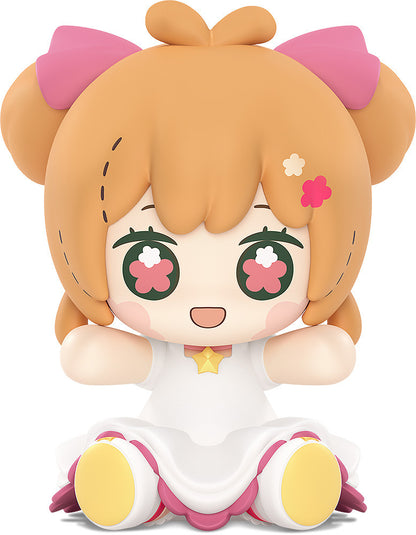 Sakura hugging staff with joyful expression and sparkling dress