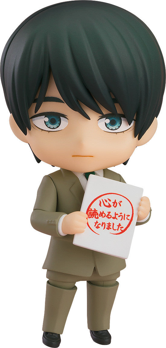 Nendoroid action figure of a dark-haired character in a tan suit holding a white sign with red Japanese characters