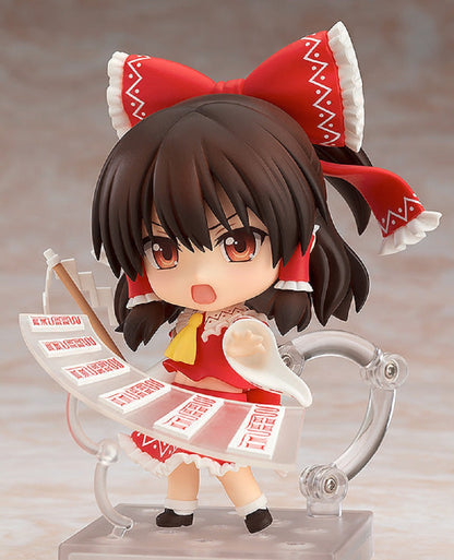 Touhou Project Nendoroid Reimu Hakurei 20 figure smiling and holding gohei wand in one hand and spell tag