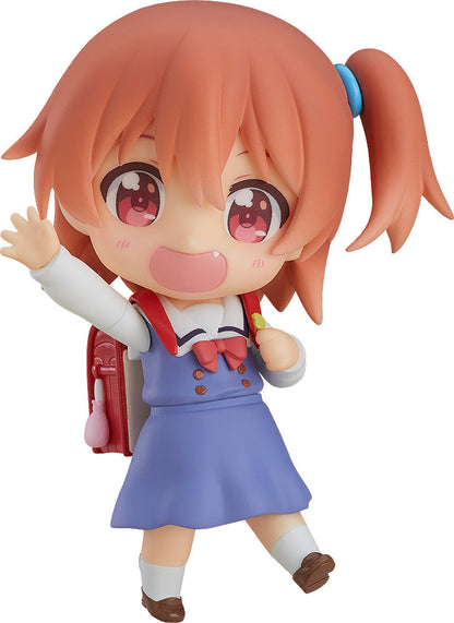 Nendoroid of a girl with pink hair and red eyes wearing a blue dress with a backpack waving on white background