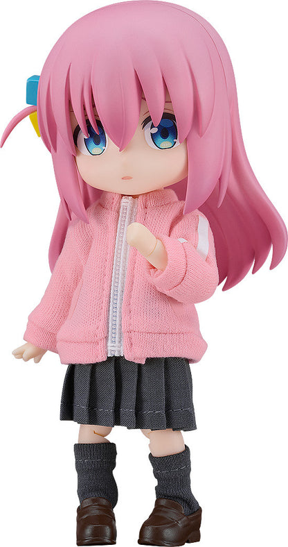Nendoroid of Bocchi the Rock's Hitori Gotou in a pink jacket gray skirt and dark gray socks on white background