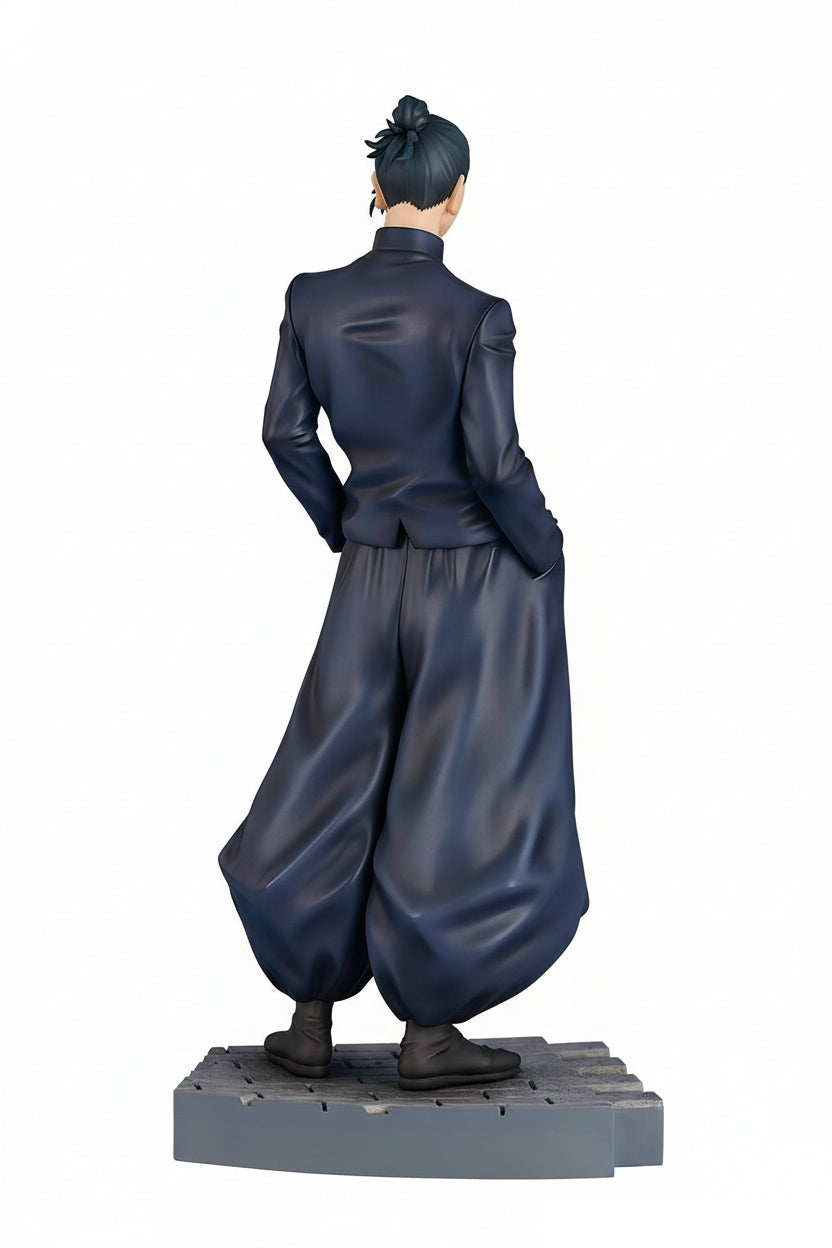 A male anime figure from the back wearing a dark uniform with wide pants and hair in a bun stands on a grey textured base
