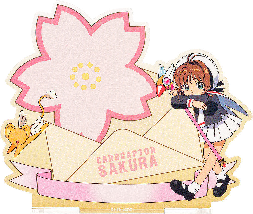 Good Smile Company Cardcaptor Sakura 25th Anniversary Acrylic Pen Stand School Uniform cardcaptor sakura and keroberos with a large pink sakura flower, envelope, and ribbon design