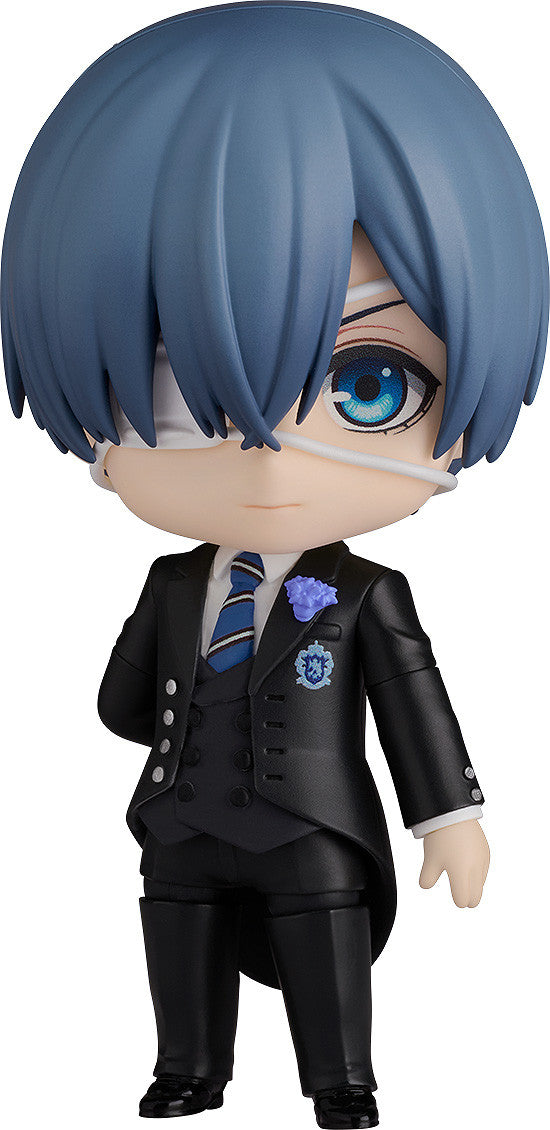 Nendoroid figure of a boy with blue hair, white eye band, one blue eye, black suit, blue tie, and purple flower