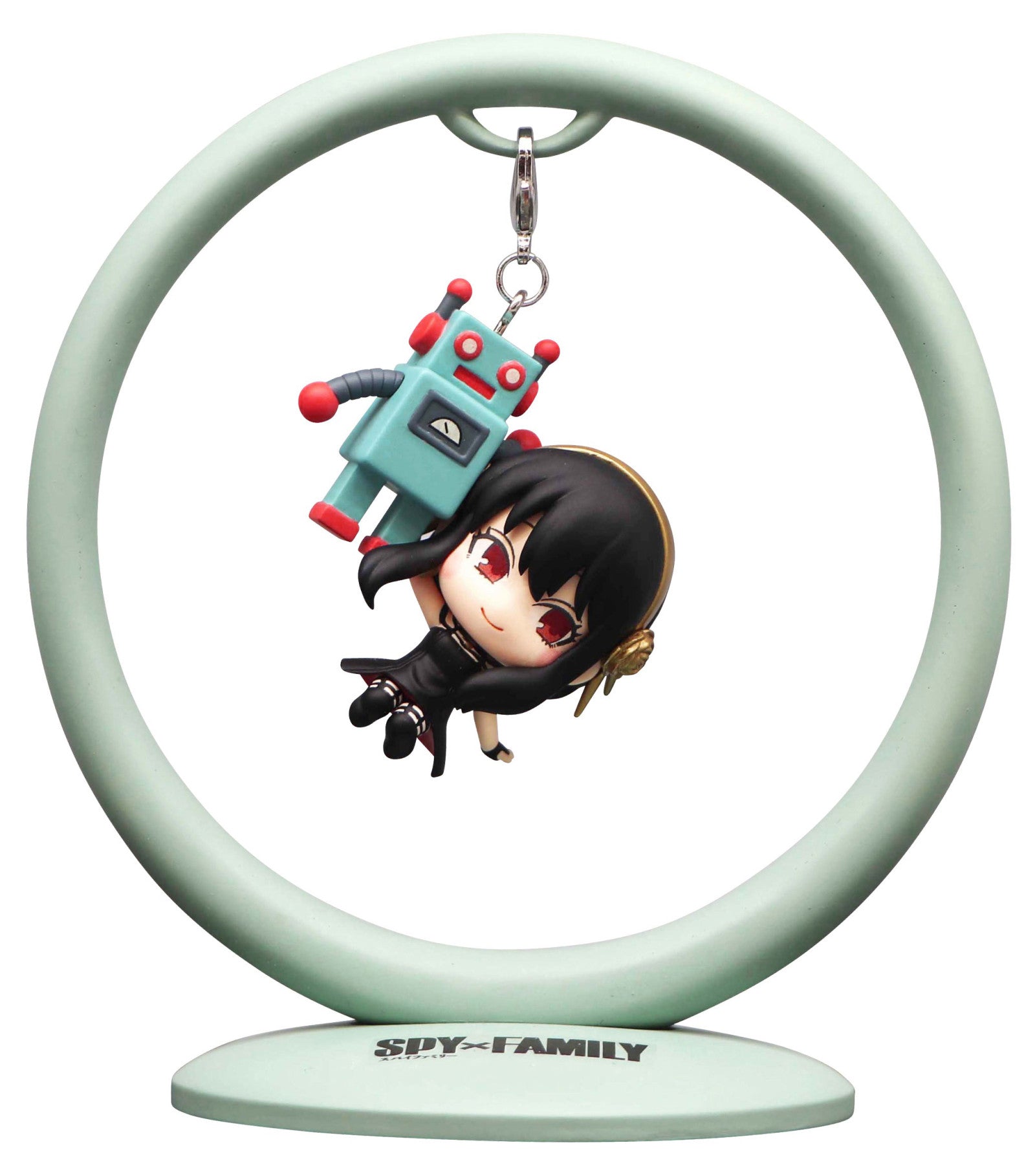 A Spy x Family chibi figure of Yor Forger holding a small blue robot suspended from a light green circular stand