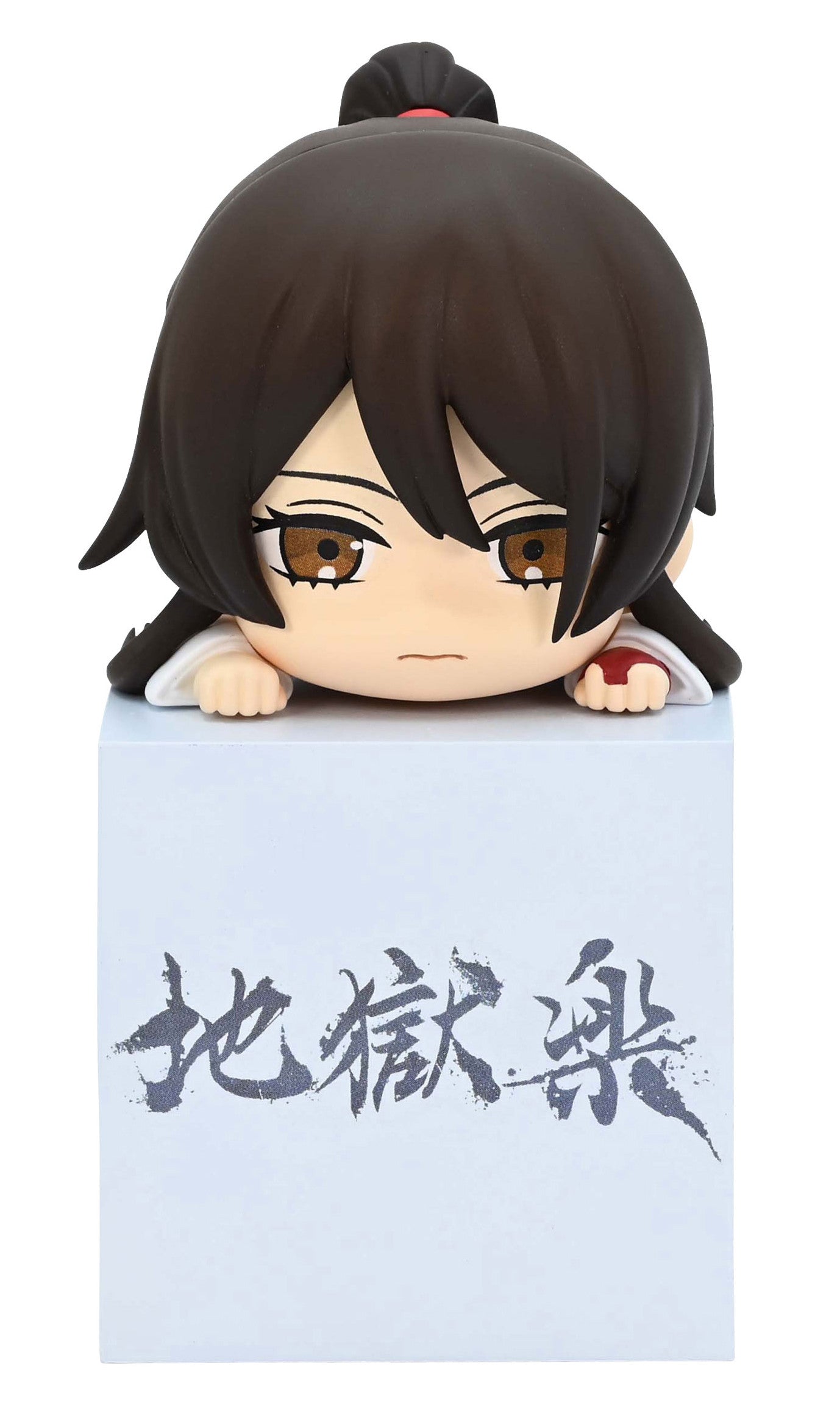 Chibi anime figure with brown hair peeking over a white box with gray Japanese characters