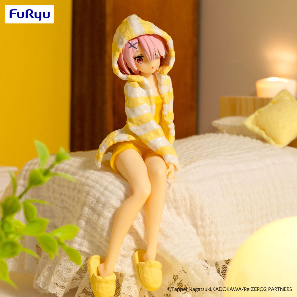 Ram anime figure, wearing yellow striped pajamas and slippers, sitting on a miniature bed