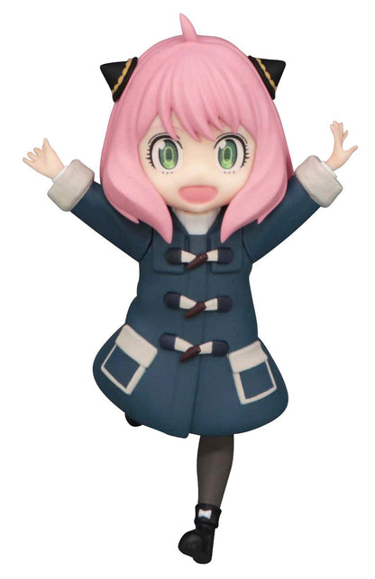 Anya seated casually with arms outstretched, smiling