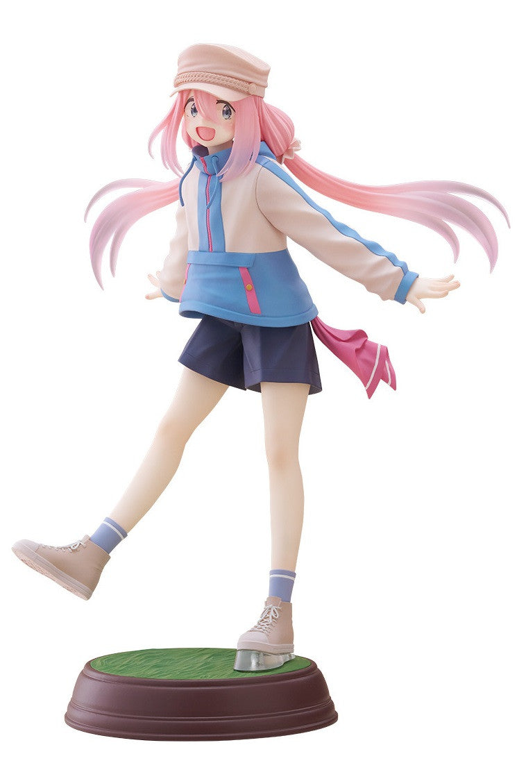 Figure of a girl with pink hair wearing a tan and blue jacket dark shorts and sneakers