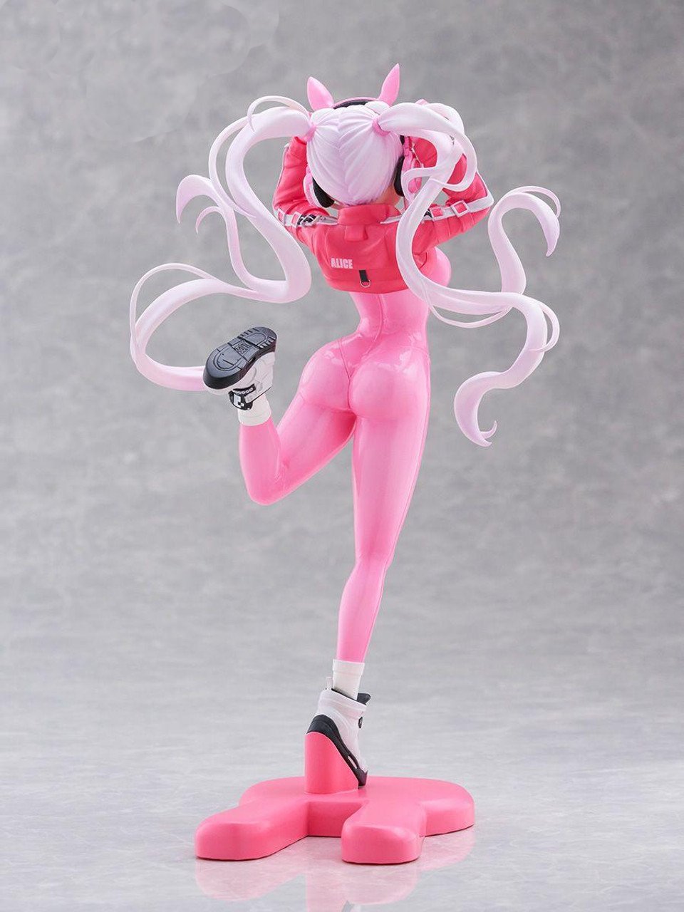 Tenitol Alice figure from Goddess of Victory Nikke wearing a pink bodysuit and jacket posing on a pink base rear view