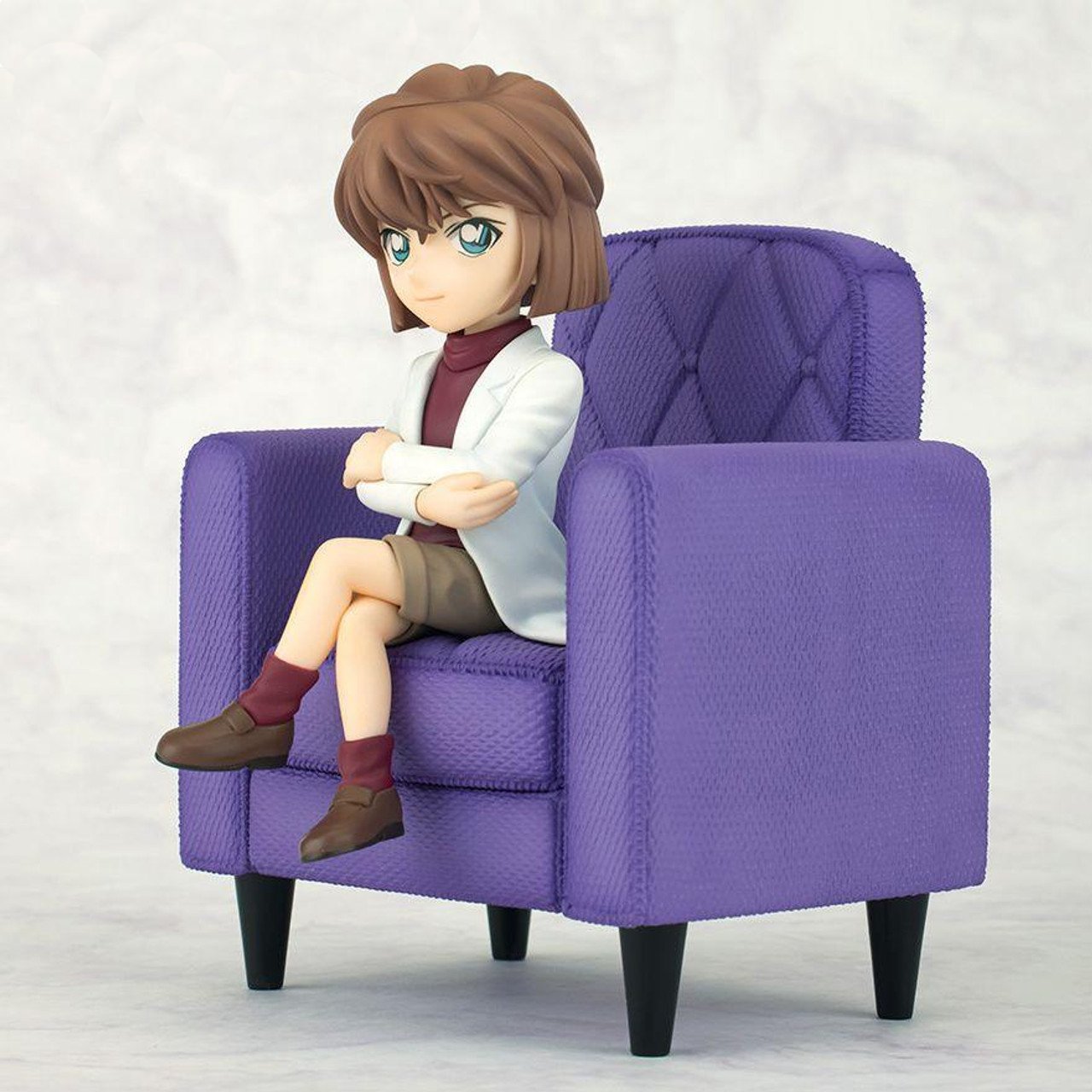 Case Closed Ai Haibara Tenitol figure sitting on a purple armchair wearing a white lab coat over a burgundy turtleneck and brown shorts