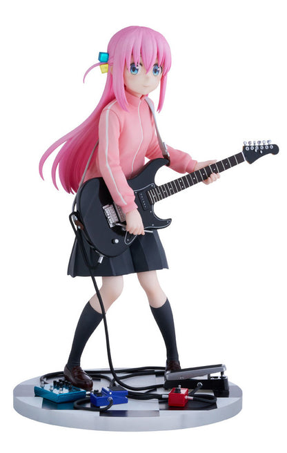 Bocchi the Rock Hitori Gotoh anime figure in pink tracksuit black skirt holding black guitar with effects pedals on checkered base