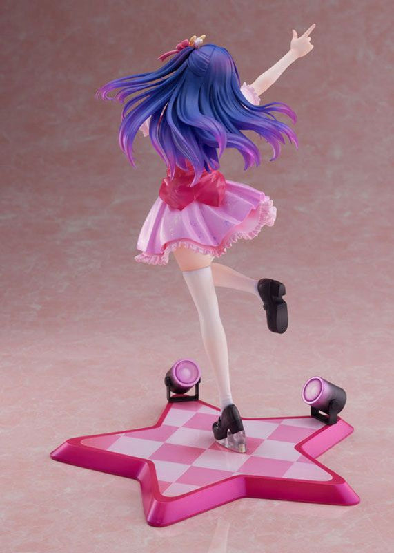 Anime figure with blue and purple hair pink dress standing on a pink star-shaped base