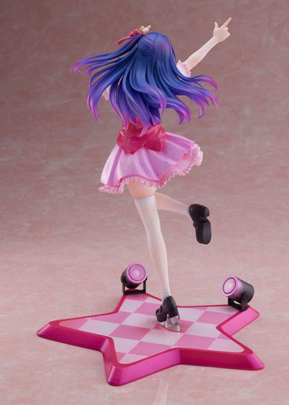 Anime figure with blue and purple hair pink dress standing on a pink star-shaped base