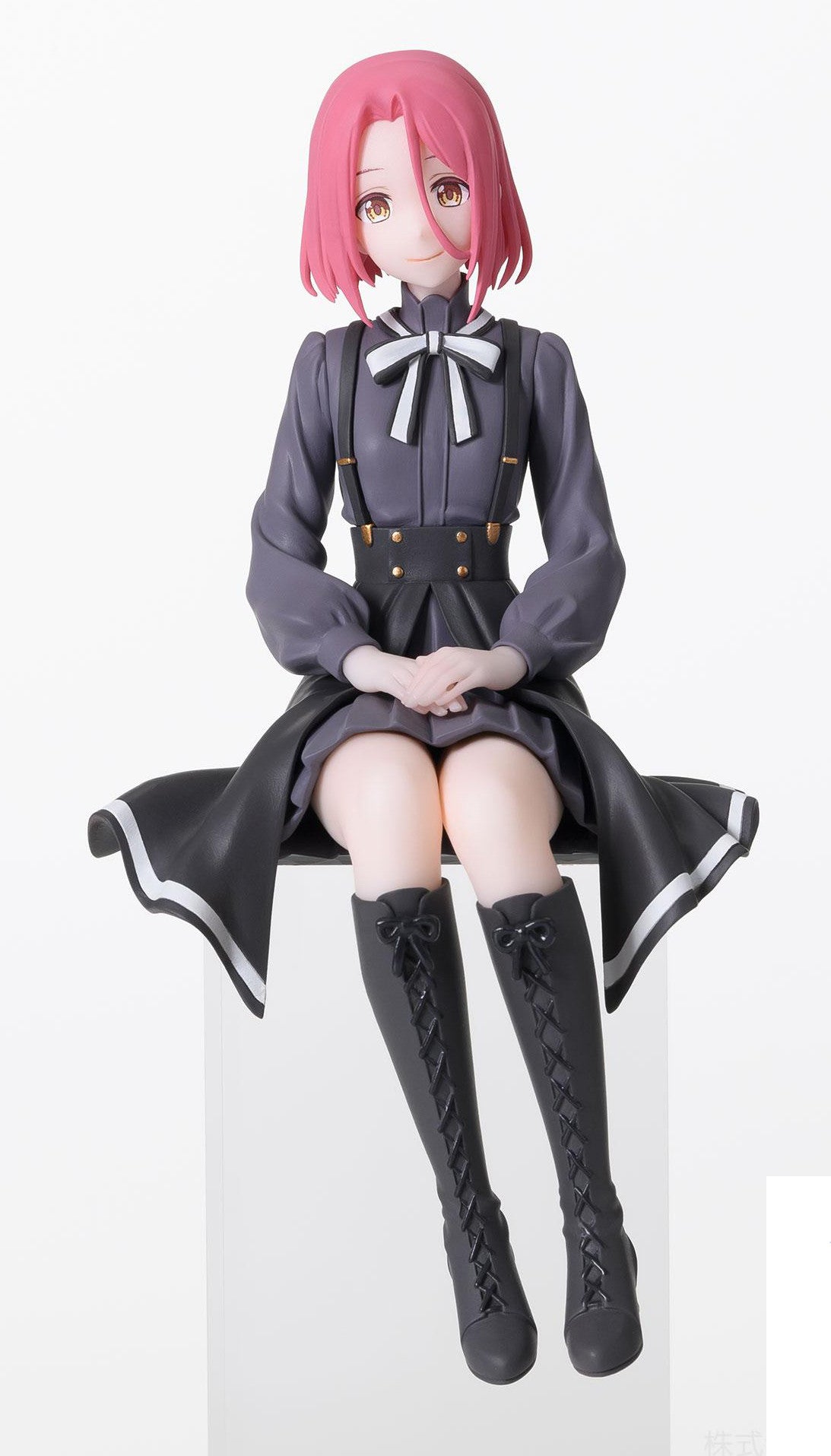 Grete sitting with legs bent to the side, giving a calm, composed look