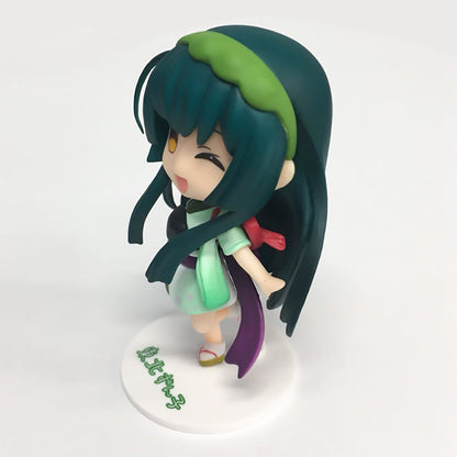 Chibi-style anime figure of Tohoku Zunko with teal hair green headband and light green kimono winking playfully