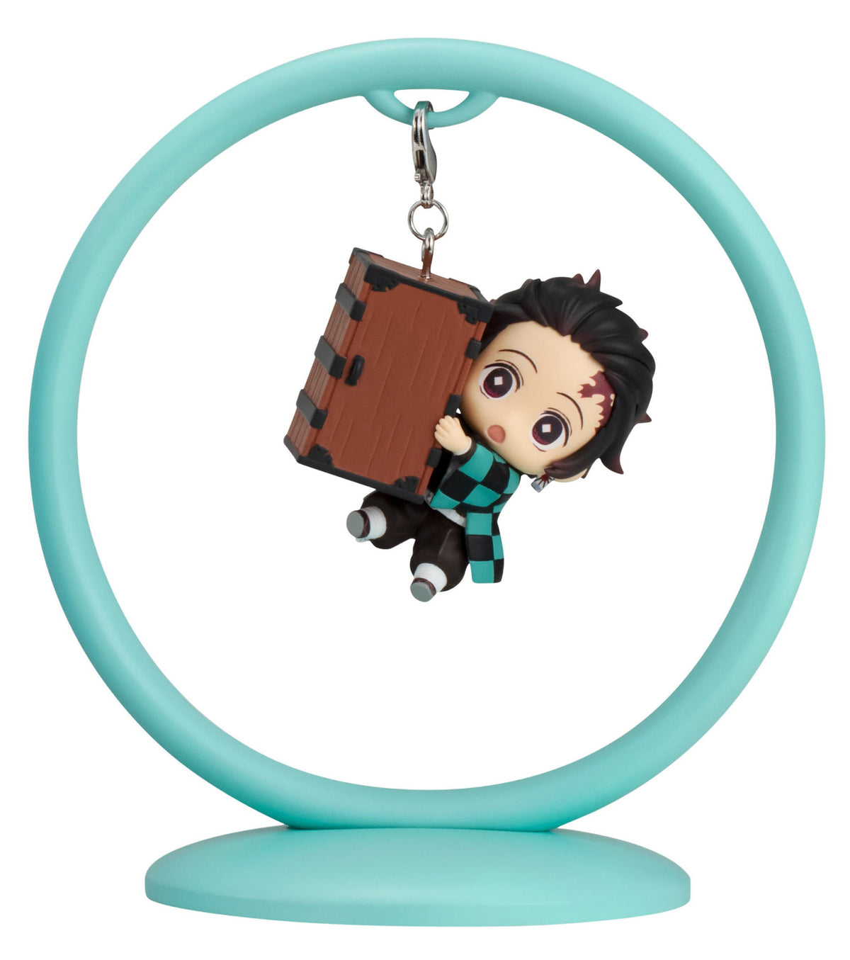 A chibi figure of Tanjiro Kamado from Demon Slayer holding a large brown box