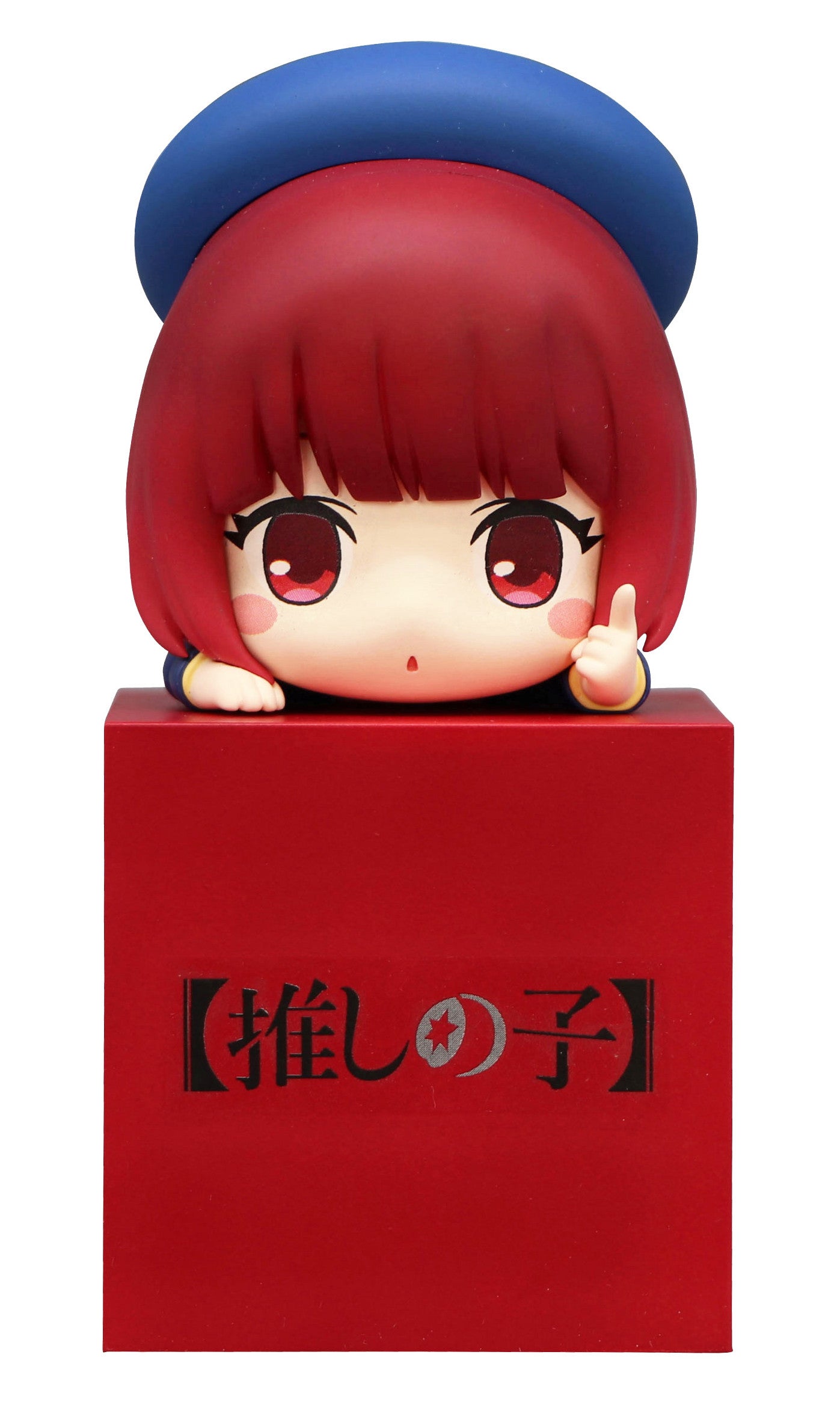 Chibi anime figure with red hair and blue hat on a red box with Japanese text