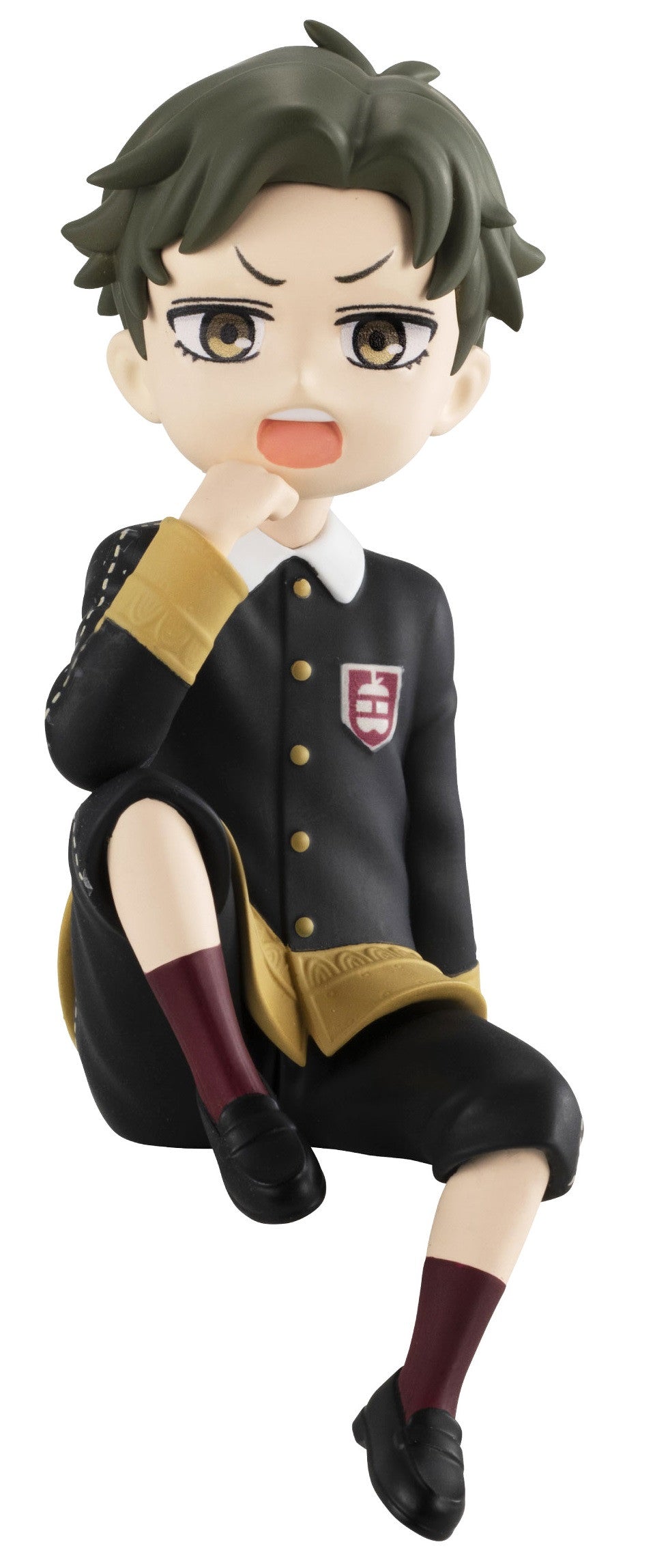 Damian Desmond sitting with arms crossed and a grumpy expression, wearing school attire