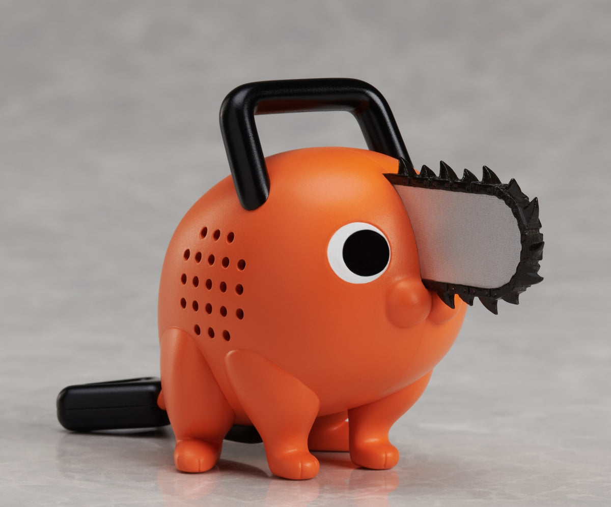Orange Pochita figure from Chainsaw Man with black saw blade and handle on a grey background