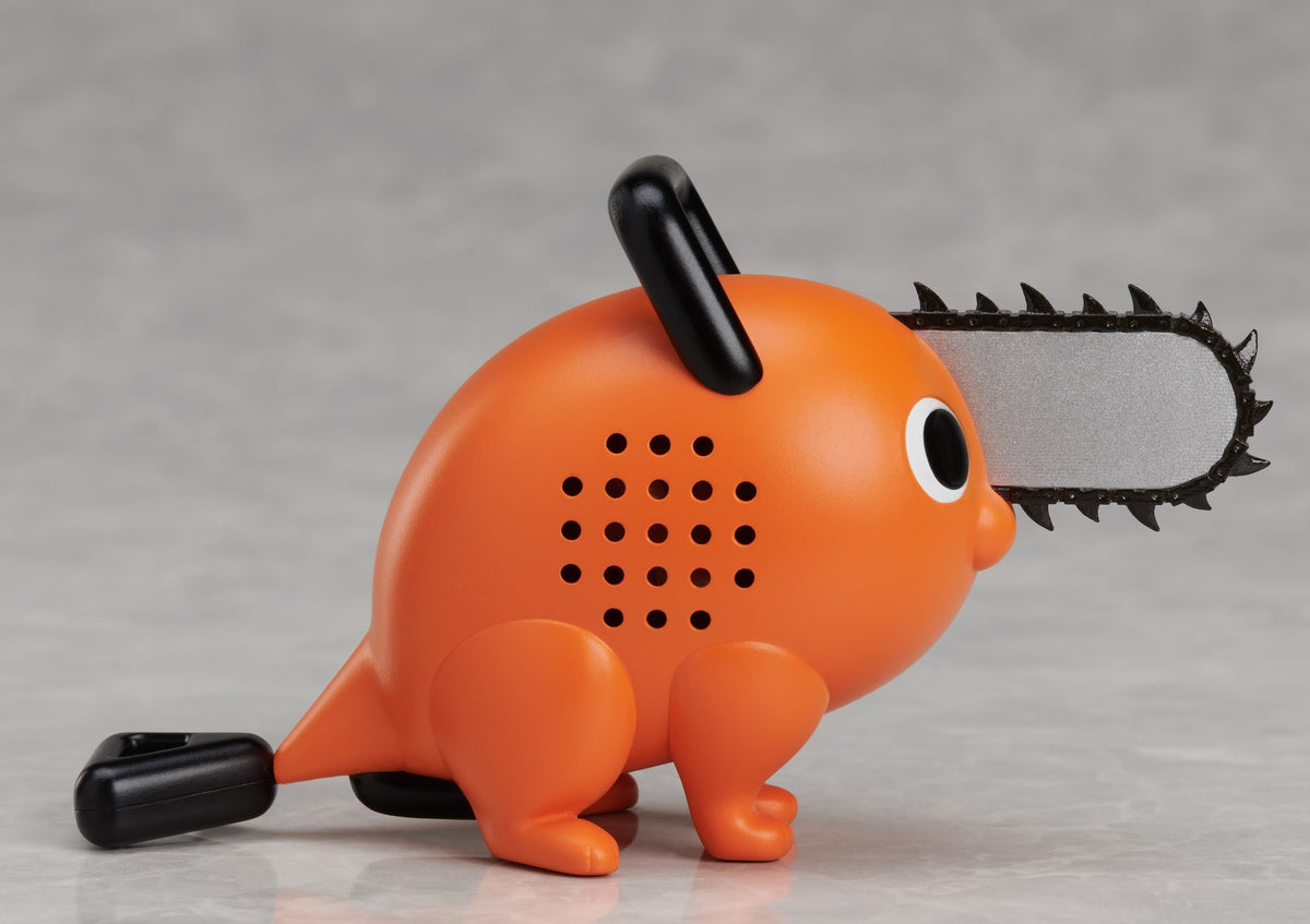Orange Pochita figure from Chainsaw Man with a black chainsaw blade and handle posed on a grey surface