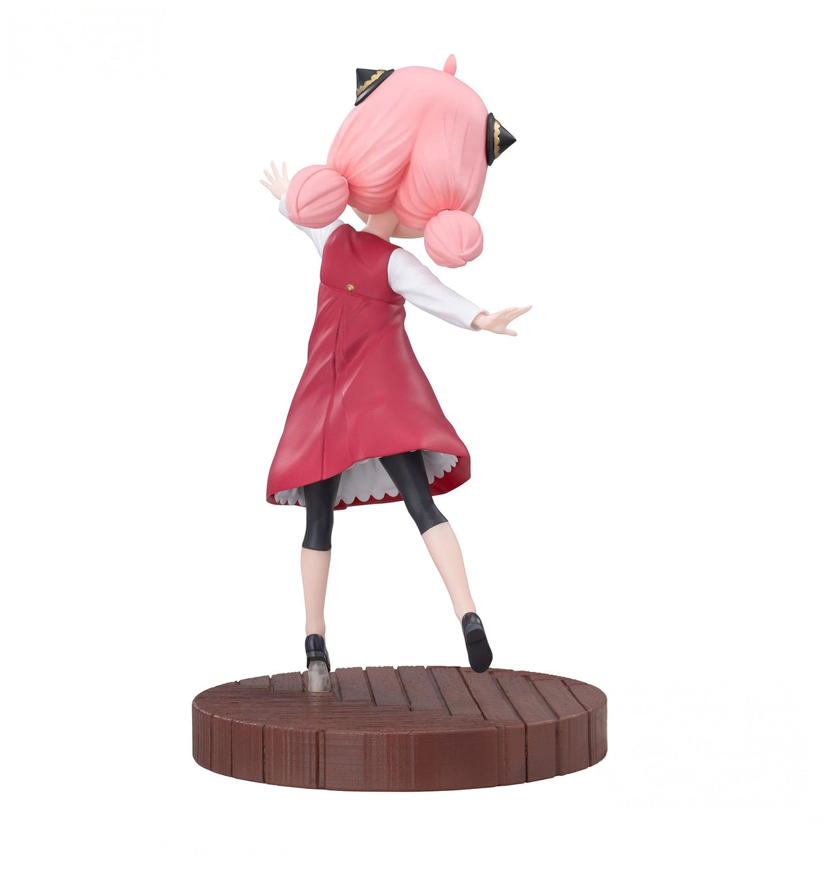 Spy x Family Anya Forger Luminasta figure with pink hair in pigtails red dress and black leggings on wood platform