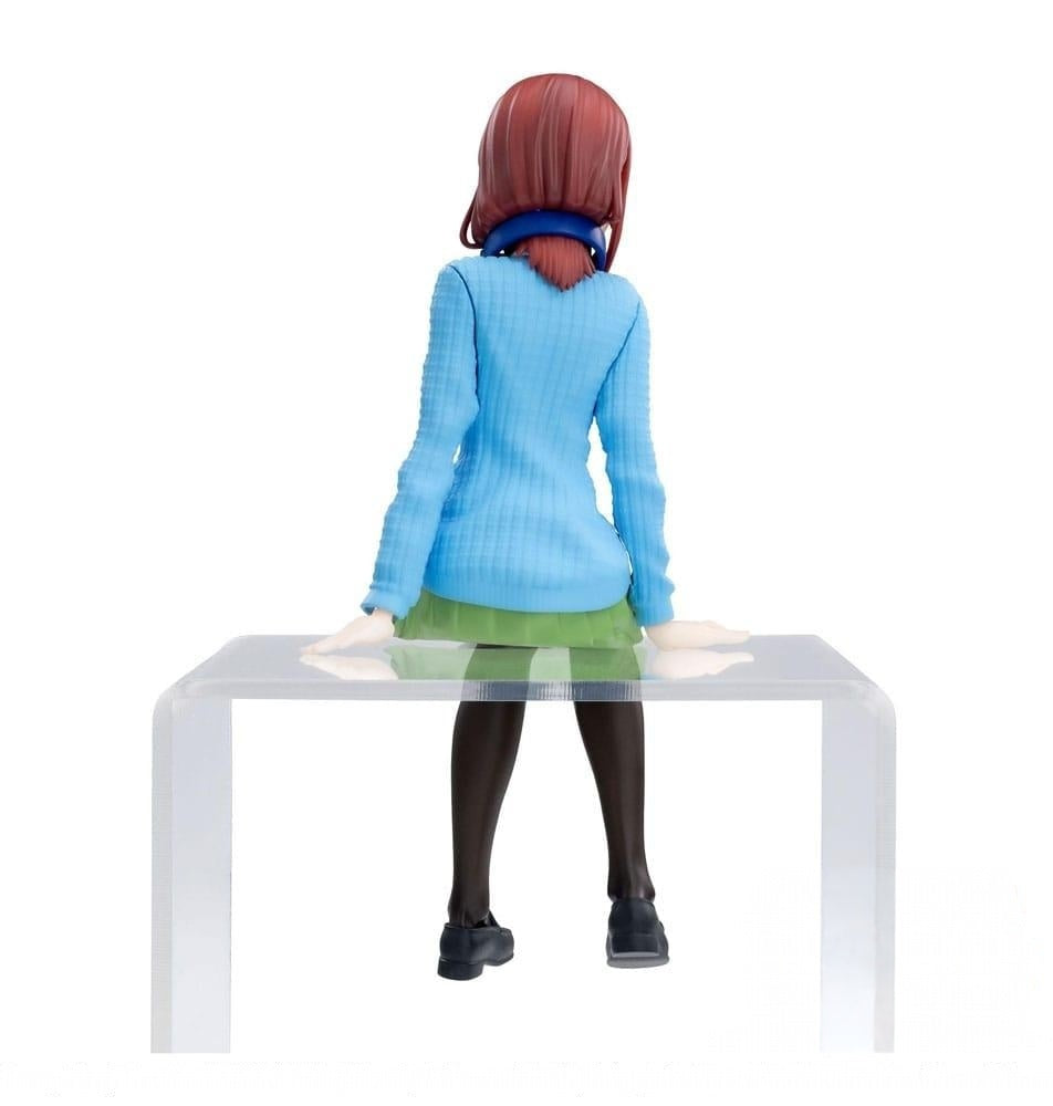 The Quintessential Quintuplets PM Perching Figure Miku Nakano figure viewed from behind wearing a blue sweater green skirt and black tights perched on a clear plastic surface