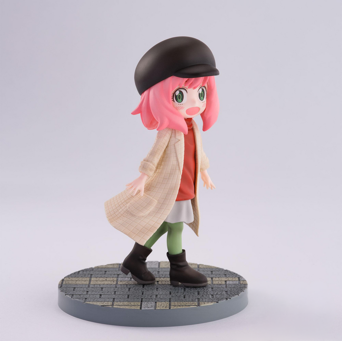 Spy x Family Luminasta Anya Forger figure in Stylish Look outfit wearing a black hat beige coat orange shirt and green tights standing on a textured base
