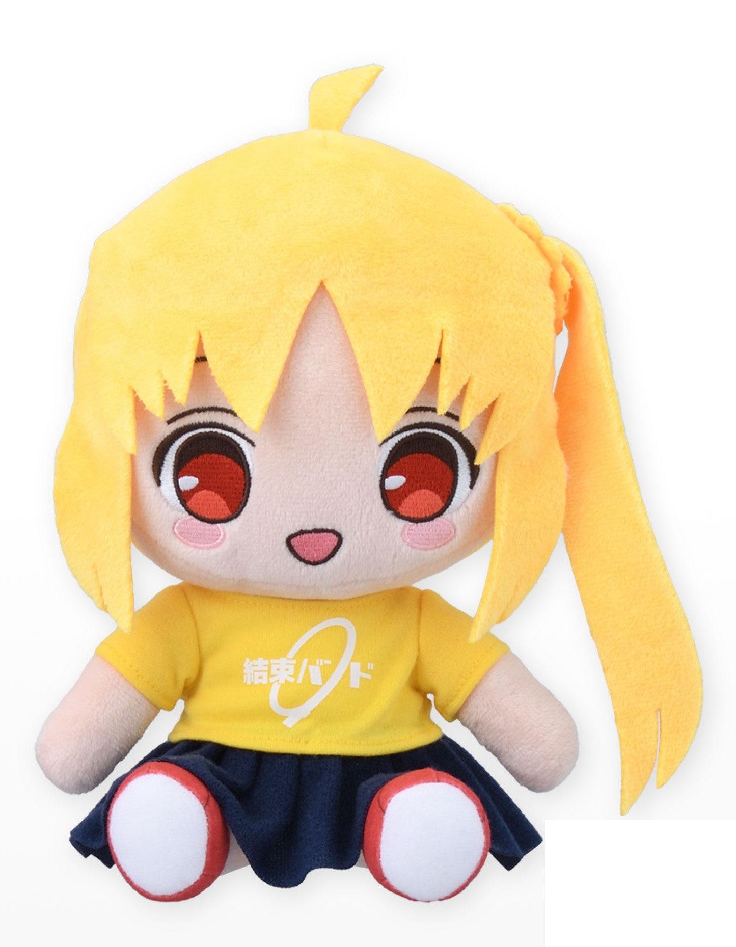 Yellow plush doll with short bangs and a long ponytail wearing a dark blue pleated skirt and a yellow t-shirt with Japanese text