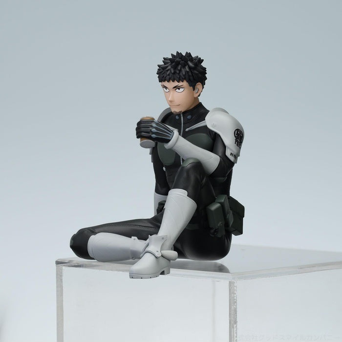 Side view of a collectible figure of a man in a black and gray futuristic suit holding a cup of coffee and sitting on a clear block