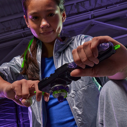 Girl holding a Beyblade launcher and top, ready to battle