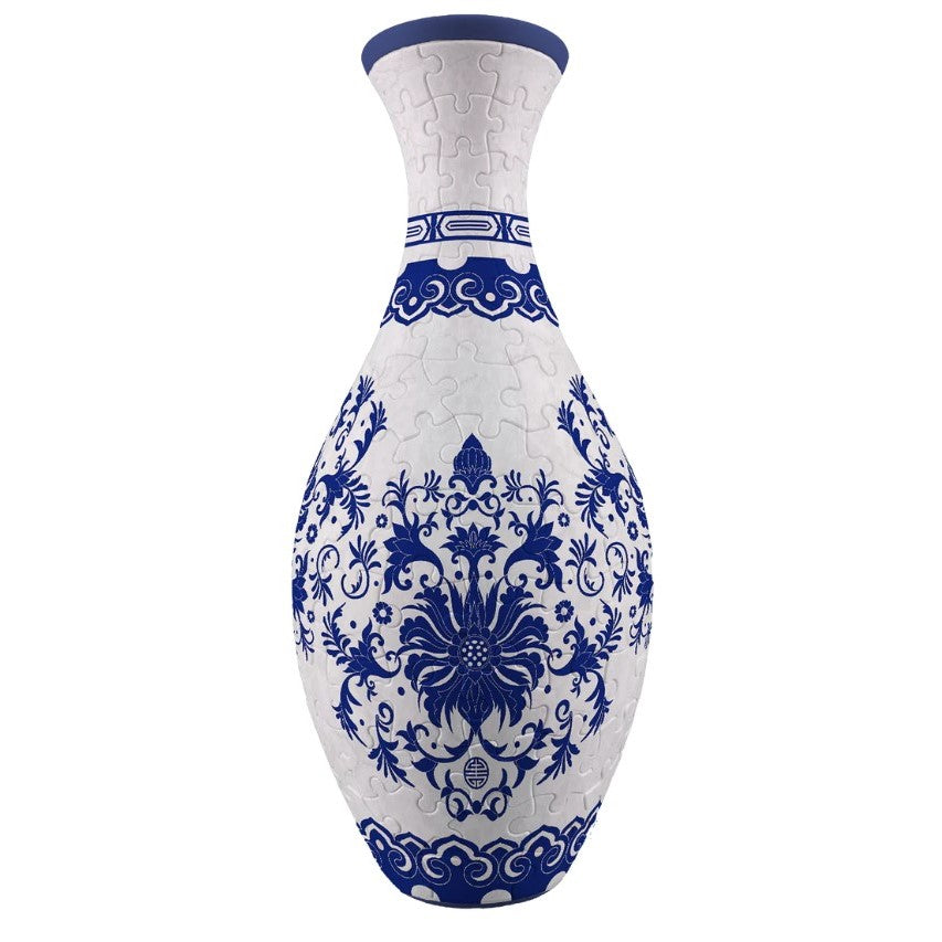 A white and indigo blue 3D puzzle vase featuring ornate floral and scroll patterns with visible puzzle piece connections forming its elegant bottle-like shape