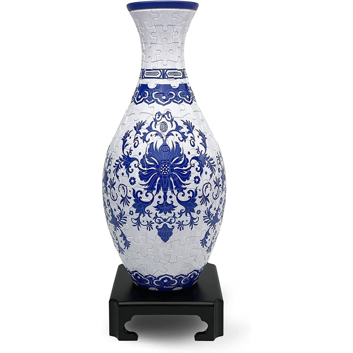 This detailed indigo floral puzzle vase, assembled from visible interlocking pieces, features classic blue and white patterns and stands on a black display base