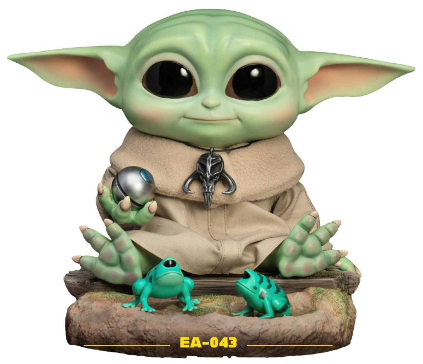 Grogu from Star Wars The Mandalorian figure holding a silver ball with two teal frogs on a log base
