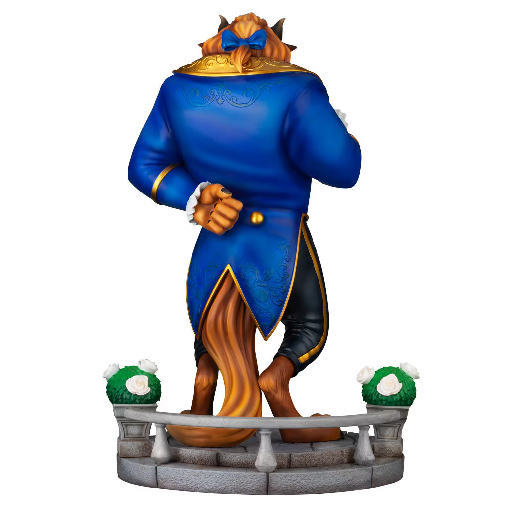 Detailed view of the Beast from Disney's Beauty and the Beast figurine from the back wearing a blue and gold coat with a blue bow in his hairs