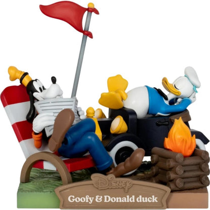 Goofy and Donald Duck roasting food over a campfire on a rustic log base