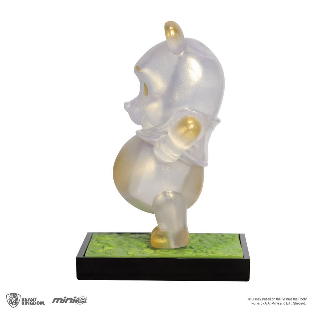 Clear Winnie the Pooh Mini Egg Attack figurine with golden accents standing on a green and black base