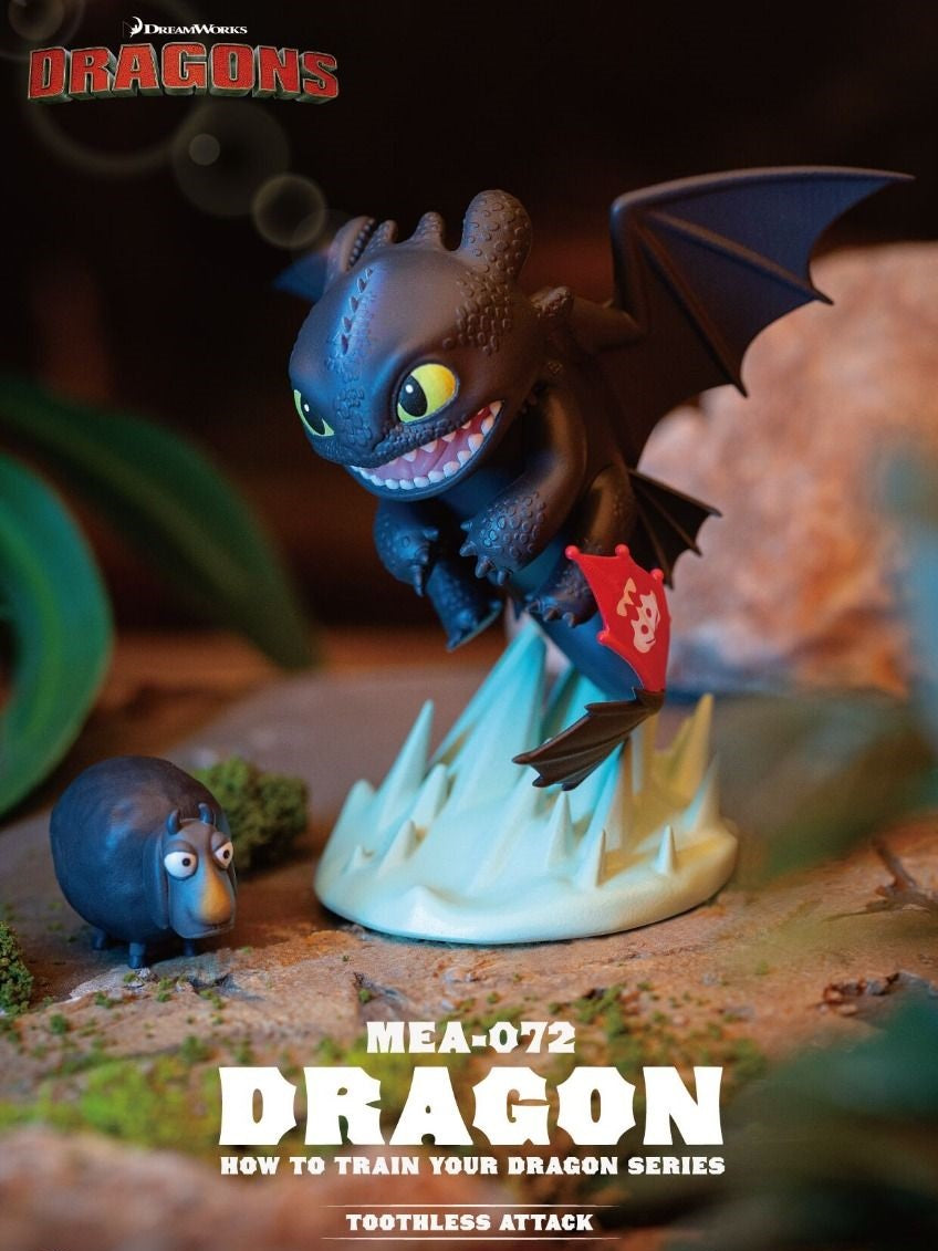 A dynamic vinyl figurine of Toothless from the How to Train Your Dragon series shows him mid-attack with bared teeth, mounted on a sharp ice formation next to a tiny black sheep accessory