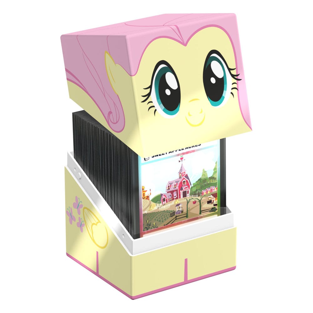 Ultimate Guard Squaroe deck box features a My Little Pony Fluttershy design in yellow and pink with her face on the lid and cutie mark on the base, slightly open revealing cards
