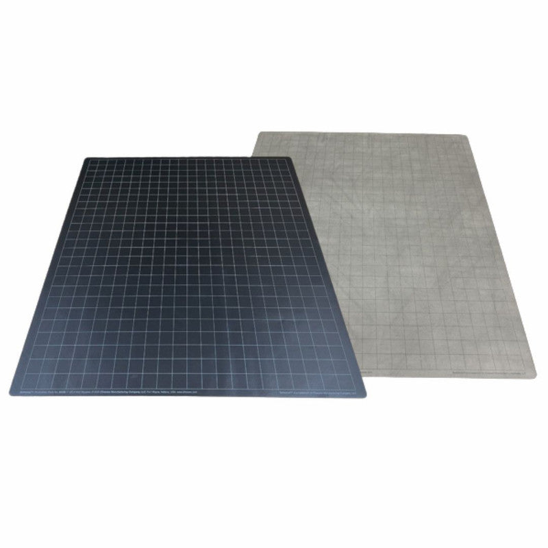 Two rectangular cutting mats with grid patterns: one dark gray, one light gray, partially overlapping