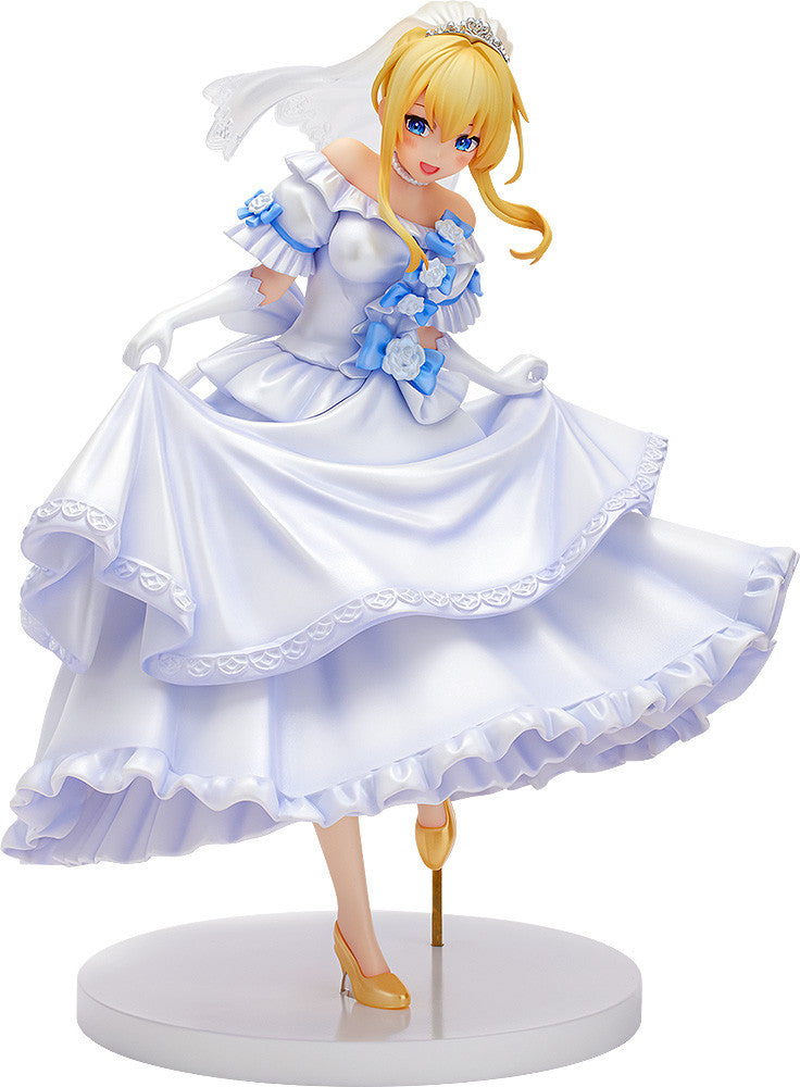 Blonde anime figure in a white, ruffled wedding dress with blue floral accents, tiara, and veil, smiling and holding up her skirt.