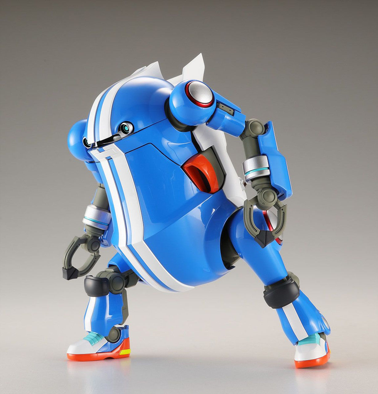Blue and white rounded mecha model, sporting stripes and sneakers, posed in a dynamic crouch