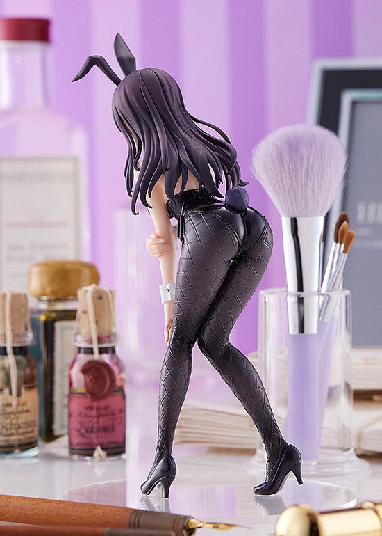 Back side view of beautiful dark haired figure in a black bunny suit with red bow tie and black textured tights