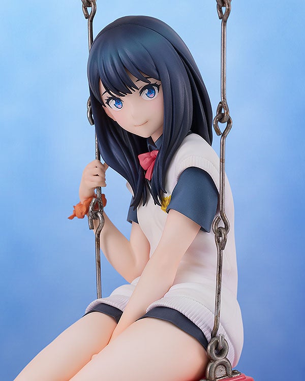 Anime girl figure with blue hair and eyes in white shirt and skirt on a swing