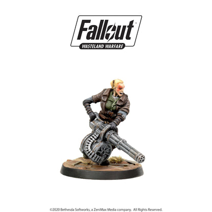 Fallout: Wasteland Warfare miniature of a fierce blonde woman with red markings, firing a large minigun
