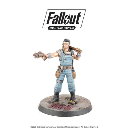 Fallout Wasteland Warfare miniature: A man in blue overalls aims a pistol, with a plank over his shoulder