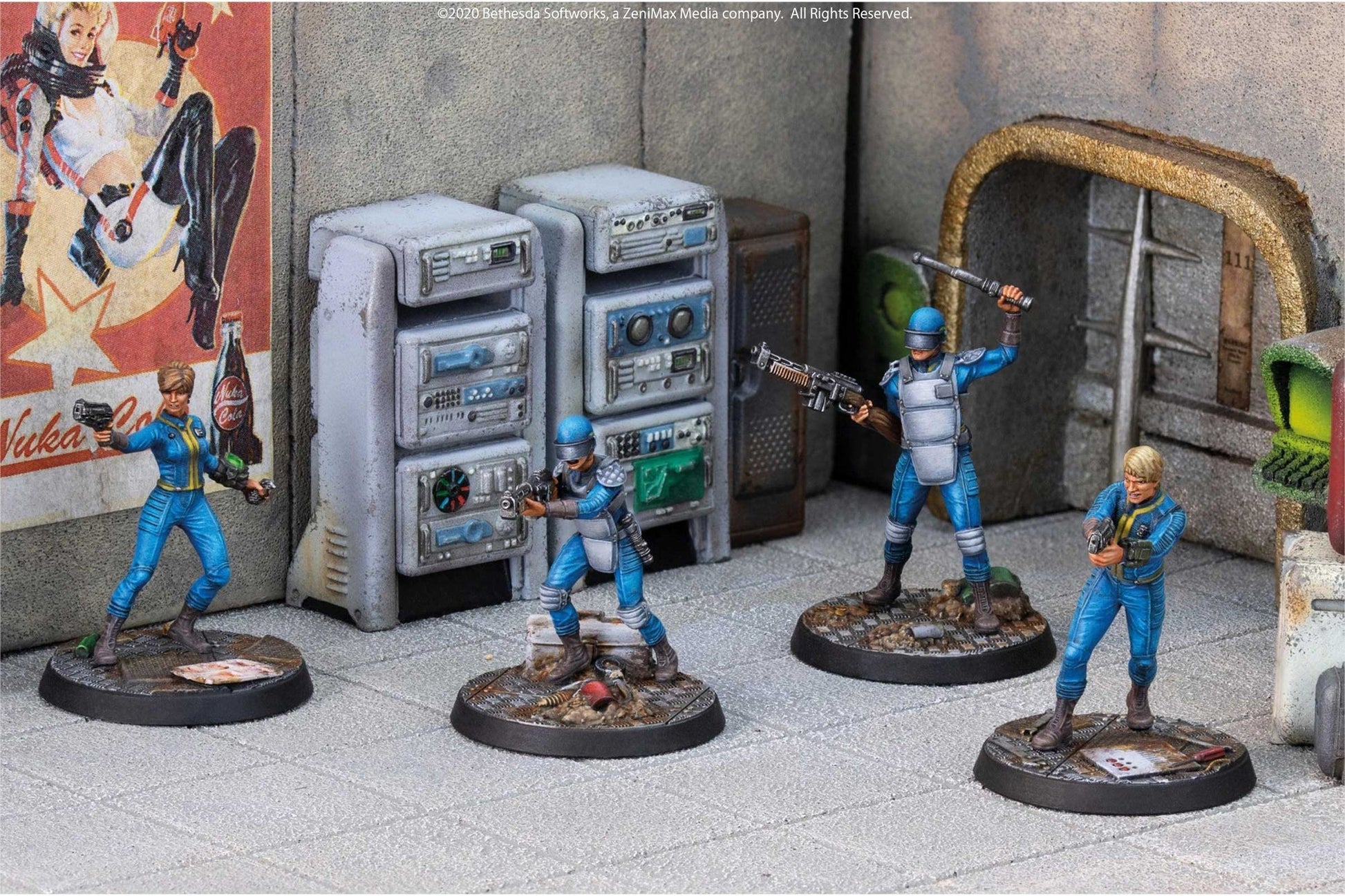 Four armed Fallout miniatures in blue jumpsuits and armor are posed in a ruined scene with a Nuka Cola poster