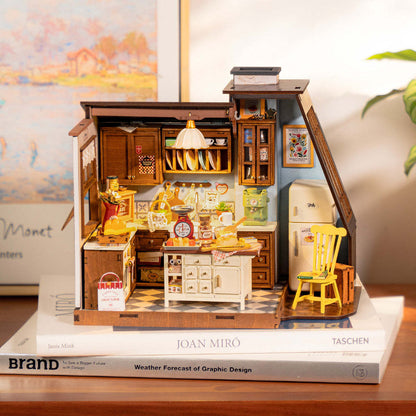 Detailed miniature wooden vintage kitchen model with a white island and accessories, sitting atop books